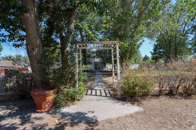 270 East 100 North Monroe, UT 84754 - Photo 46 of 65 Arbor-covered concrete pathway surrounded by mature trees and varied shrubbery