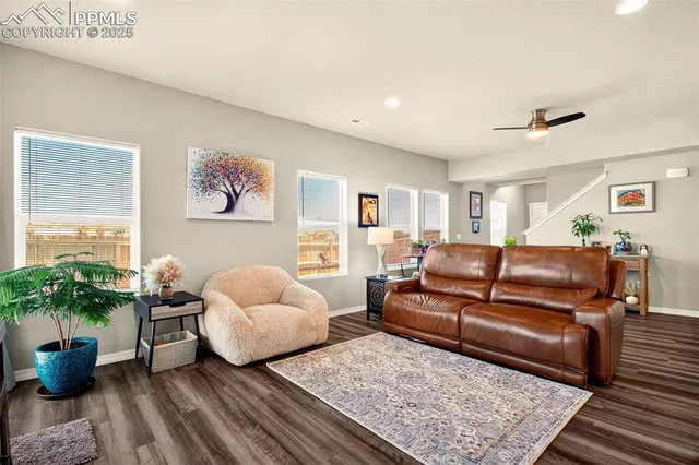 a living room with furniture and flowers