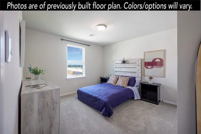 a spacious bedroom with a bed and a window