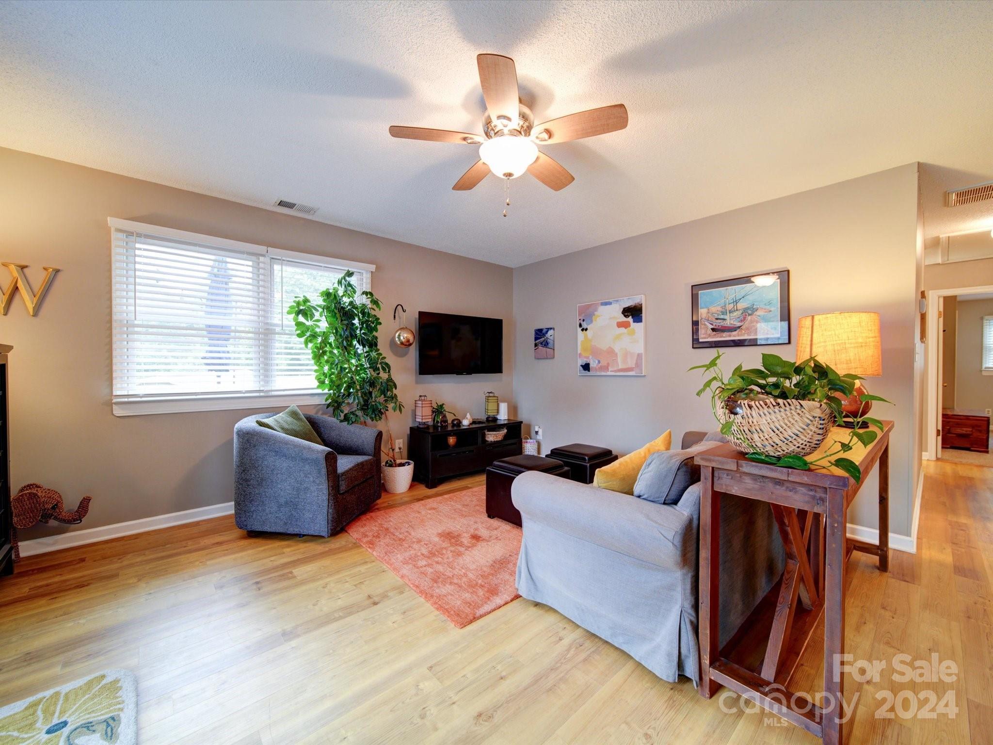 20126 Rainbow Circle Cornelius, NC 28031 - Photo 11 of 40 a living room with furniture potted plant and a window
