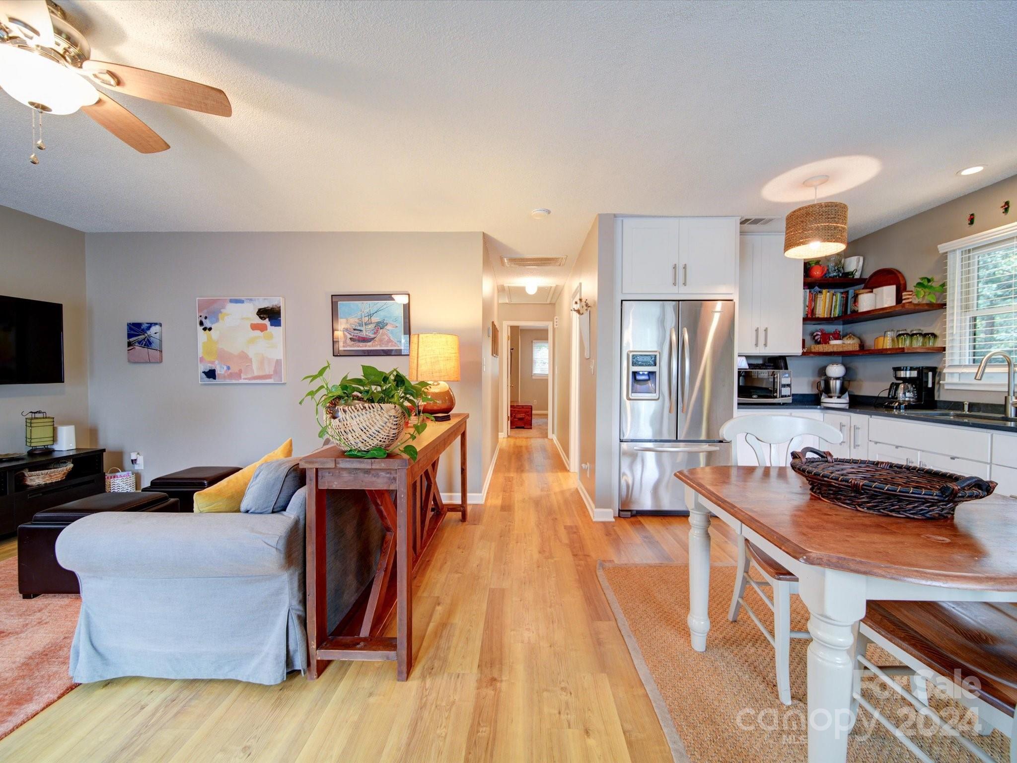 20126 Rainbow Circle Cornelius, NC 28031 - Photo 16 of 40 a living room with stainless steel appliances furniture a rug and a view of kitchen