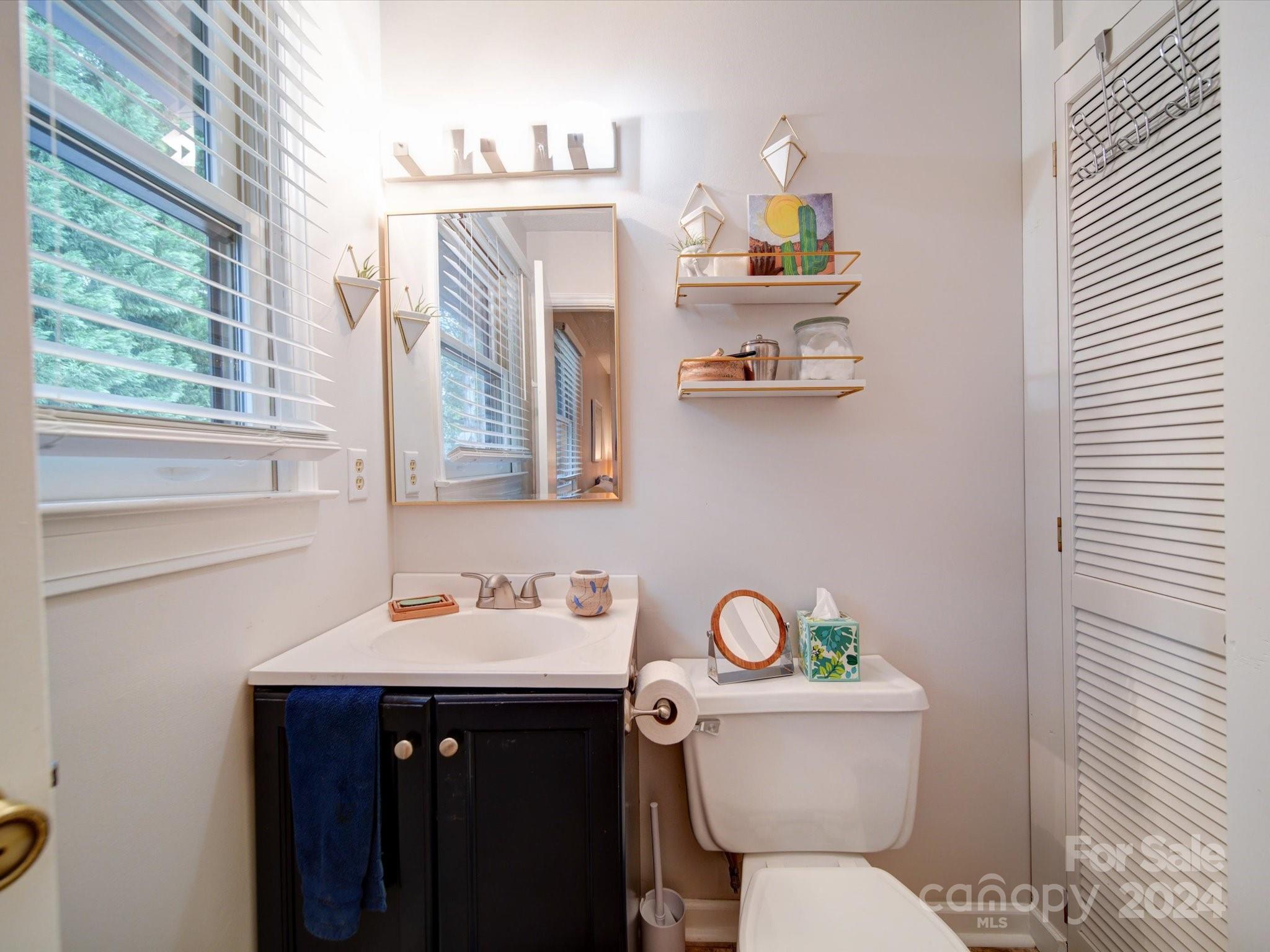 20126 Rainbow Circle Cornelius, NC 28031 - Photo 21 of 40 a bathroom with a toilet a sink and a window