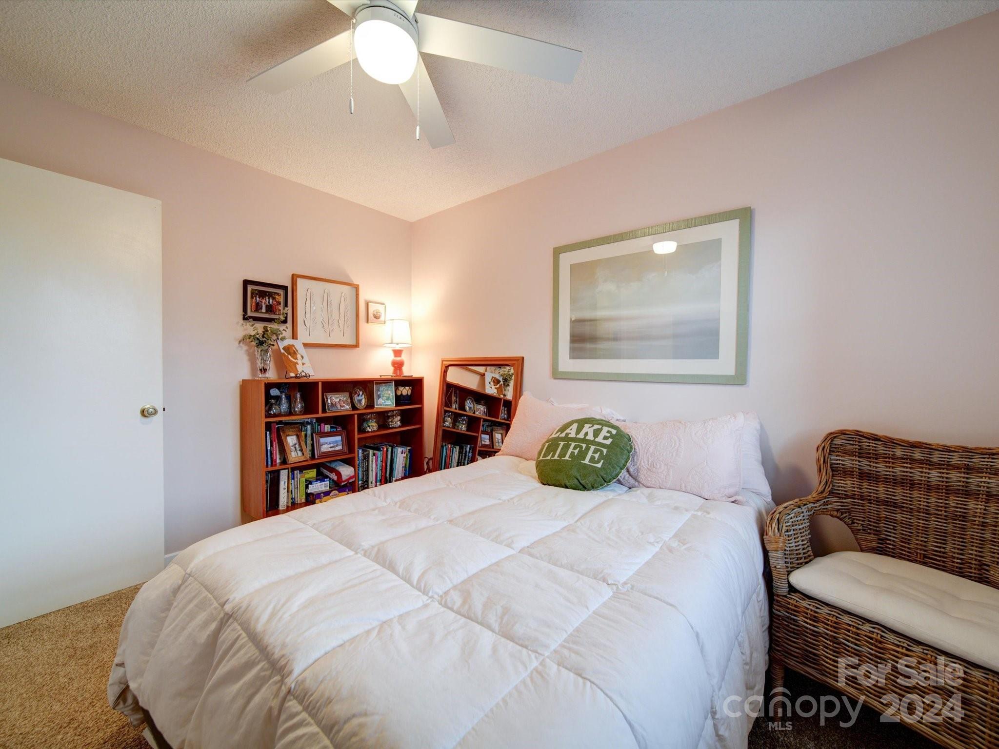 20126 Rainbow Circle Cornelius, NC 28031 - Photo 22 of 40 a bedroom with a bed and a chandelier