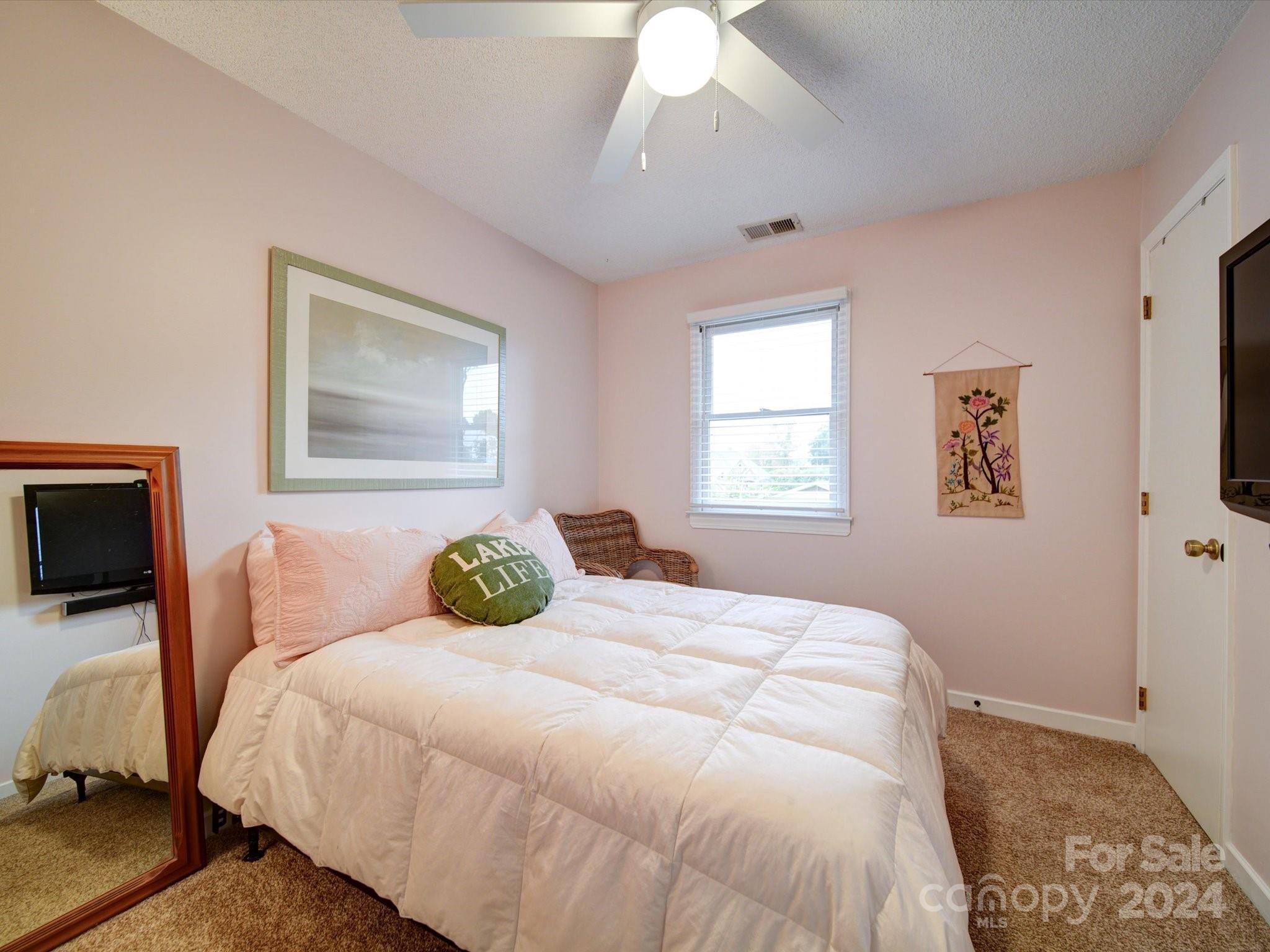 20126 Rainbow Circle Cornelius, NC 28031 - Photo 23 of 40 a bedroom with a bed and wooden floor