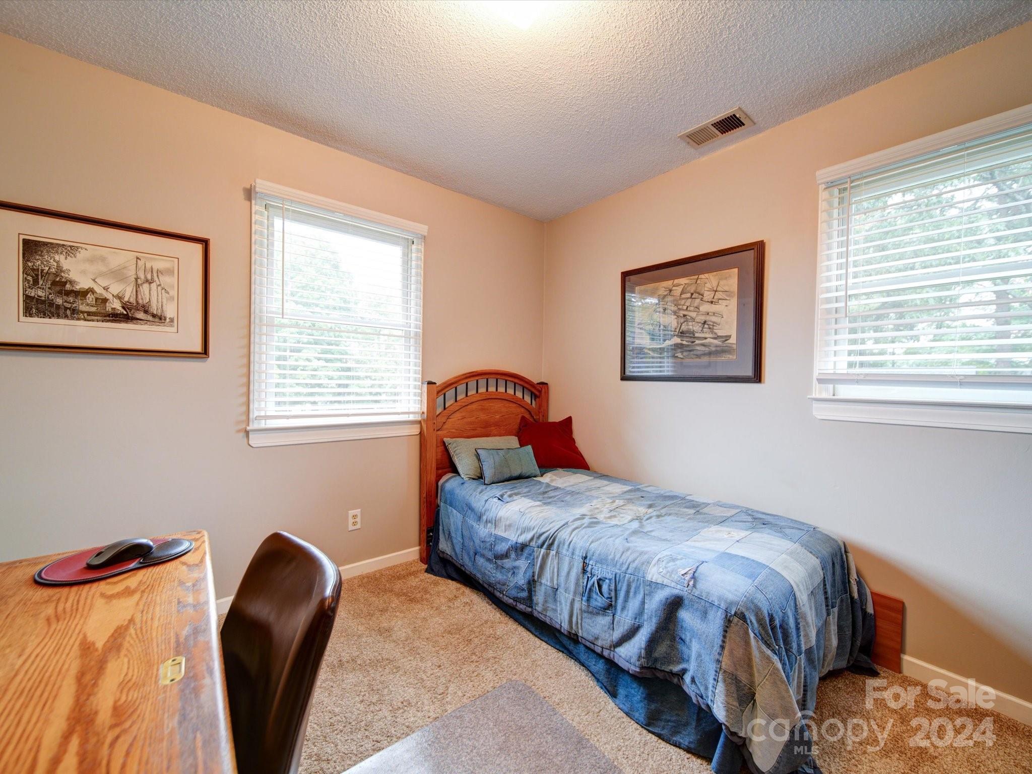 20126 Rainbow Circle Cornelius, NC 28031 - Photo 24 of 40 a bedroom with a bed and a painting on the wall