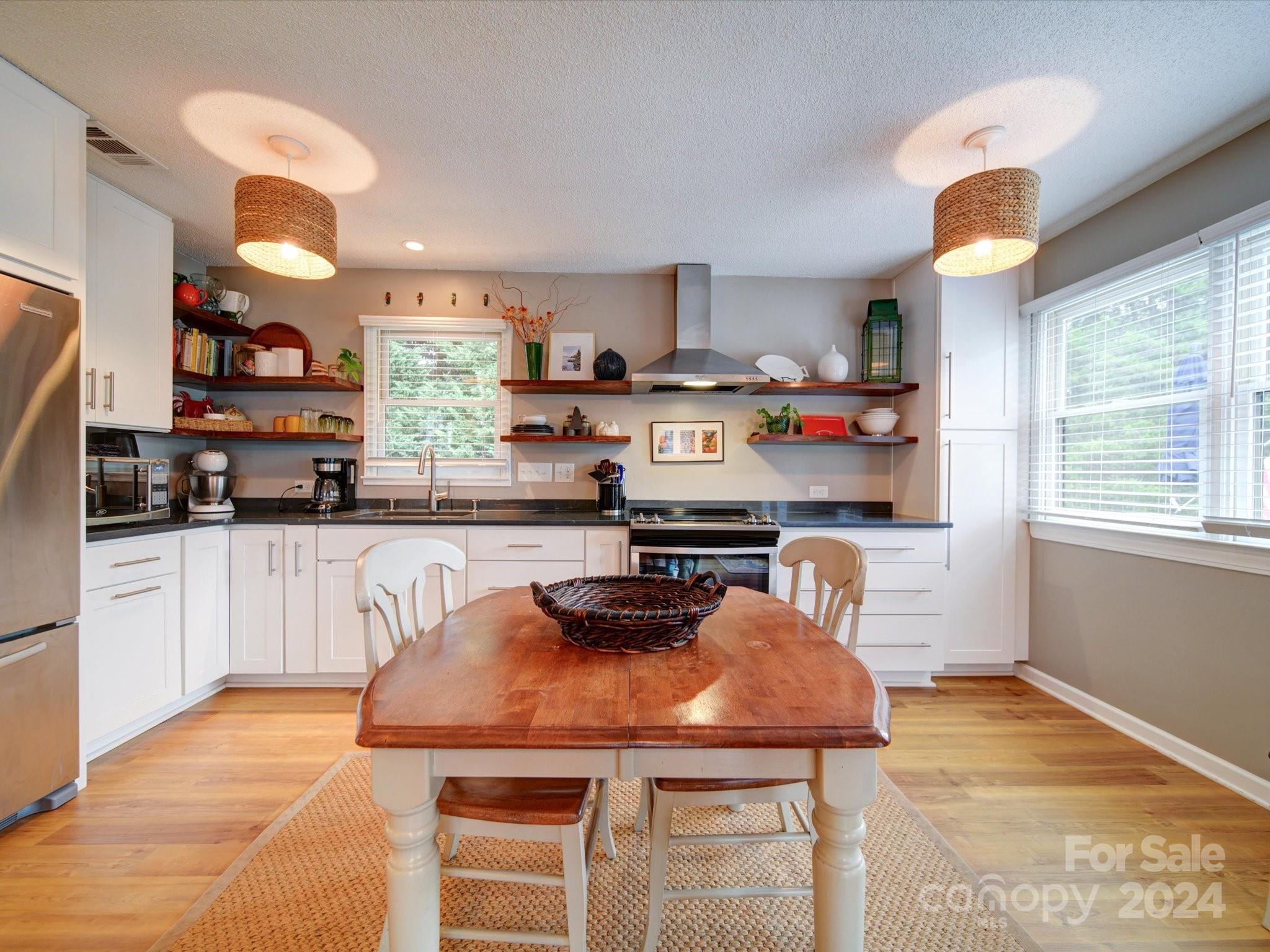 20126 Rainbow Circle Cornelius, NC 28031 - Photo 6 of 40 a kitchen with stainless steel appliances kitchen island granite countertop a sink and cabinets