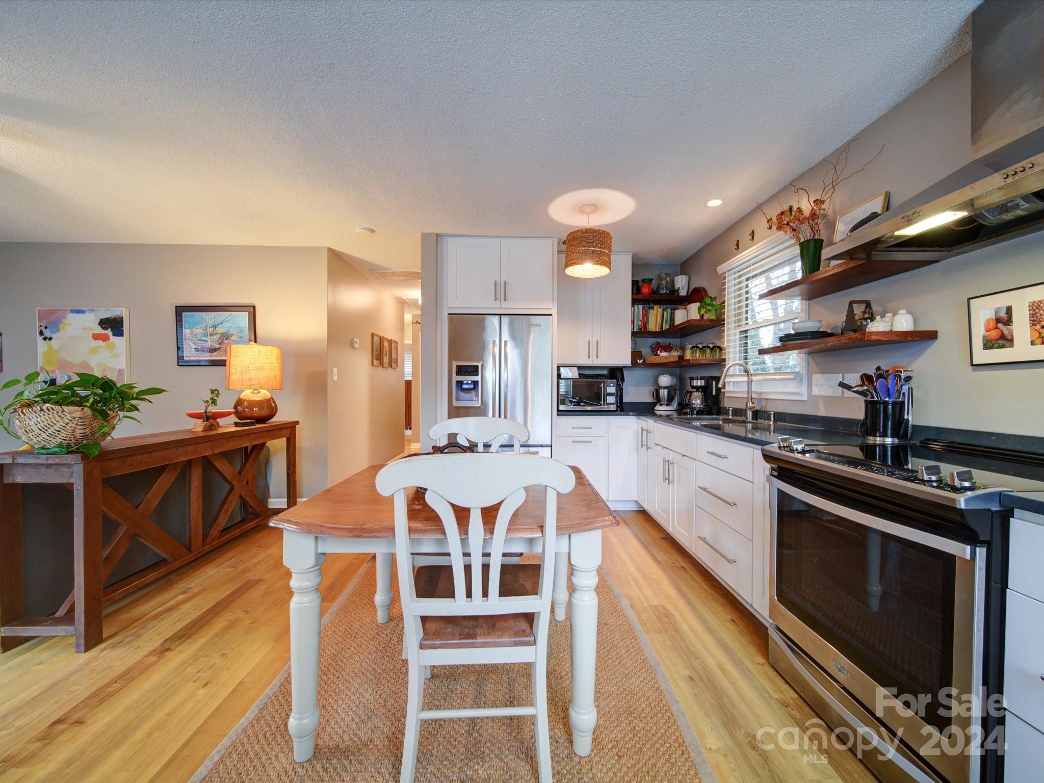 20126 Rainbow Circle Cornelius, NC 28031 - Photo 8 of 40 a large kitchen with a table and chairs