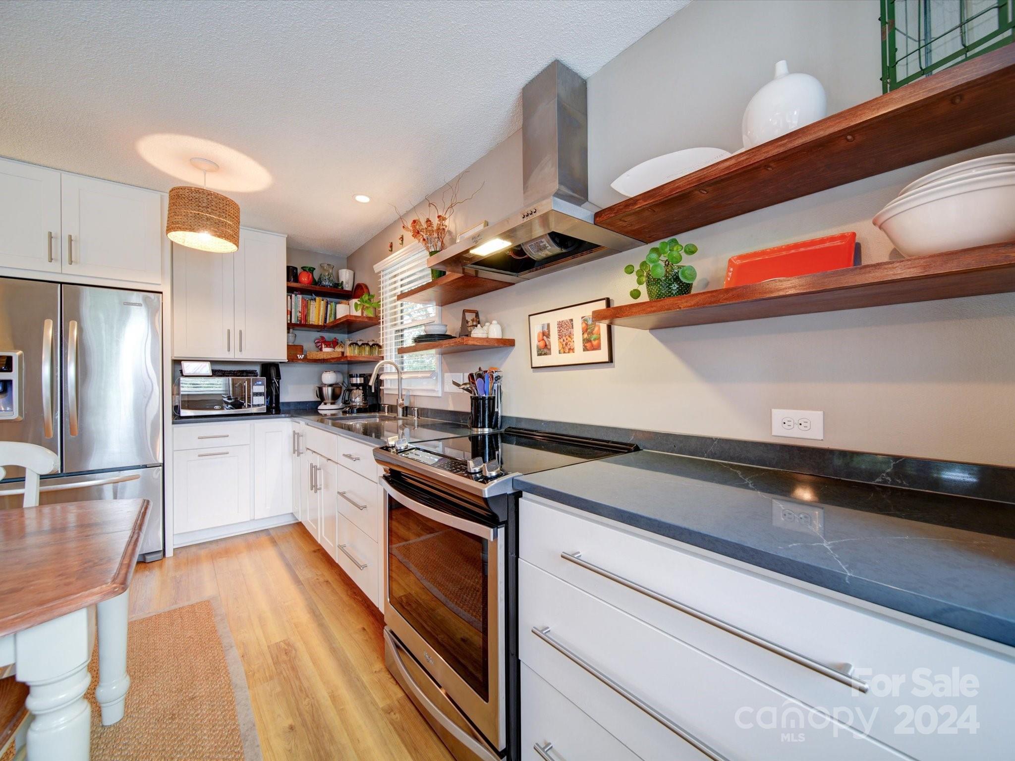 20126 Rainbow Circle Cornelius, NC 28031 - Photo 9 of 40 a kitchen with stainless steel appliances granite countertop a sink and a stove