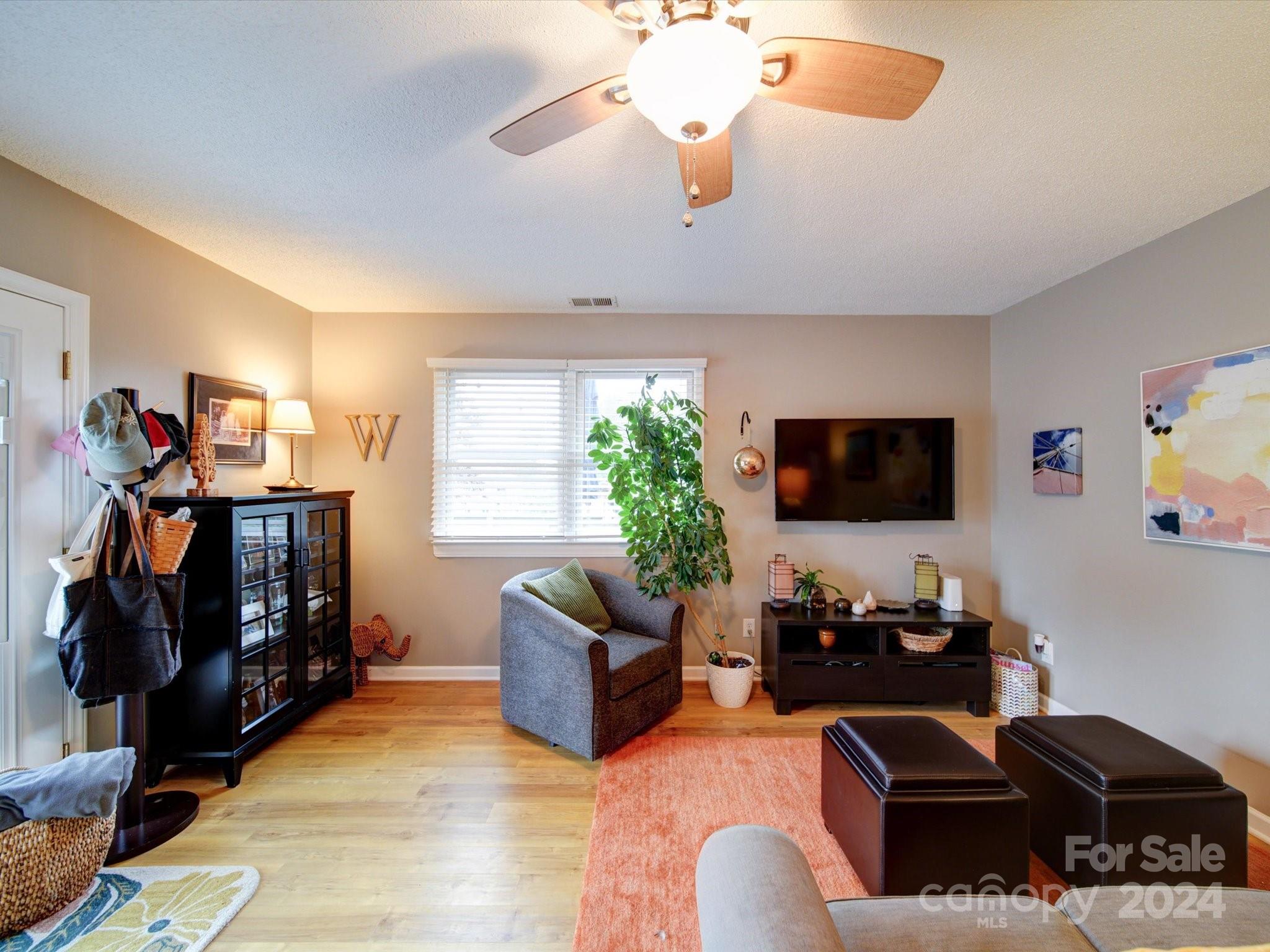 20126 Rainbow Circle Cornelius, NC 28031 - Photo 10 of 40 a living room with furniture and a flat screen tv