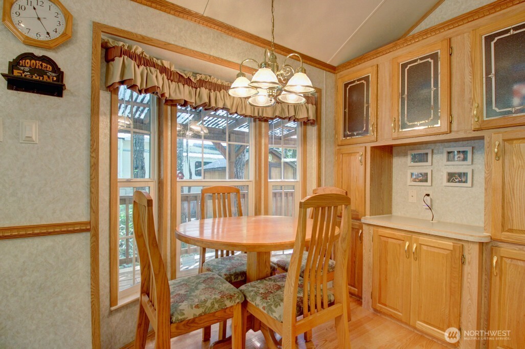 134 Drial Loop Maple Falls, WA 98266 - Photo 11 of 36 a dining room with furniture a chandelier and a window