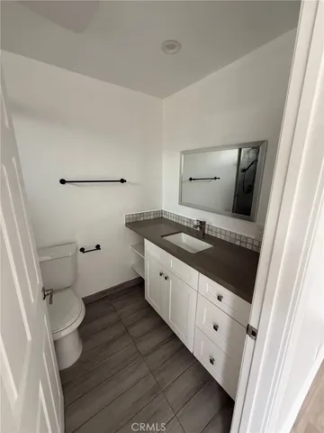 a bathroom with a sink a toilet and mirror
