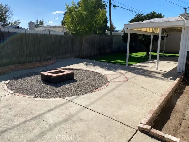 a backyard of a house with swimming pool and wooden fence
