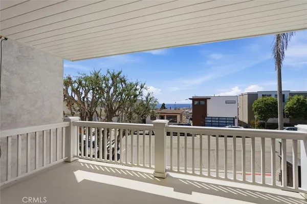 a view of a balcony with wooden floor