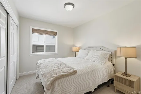 a bedroom with a bed and a lamp