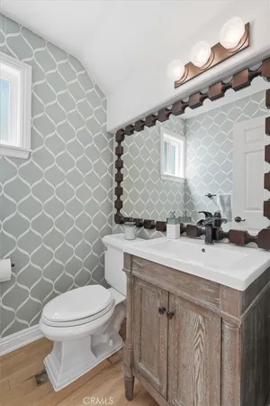 a bathroom with a sink toilet and mirror