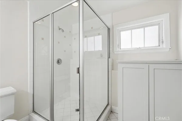 a bathroom with a shower and a toilet