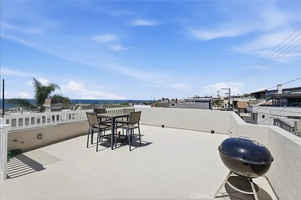 a terrace with a table and chairs