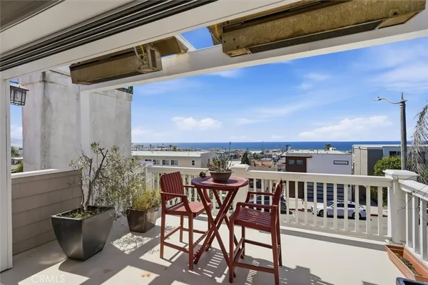 a balcony with table and chairs