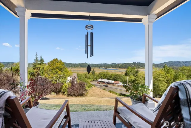 a view of a balcony with chair and table