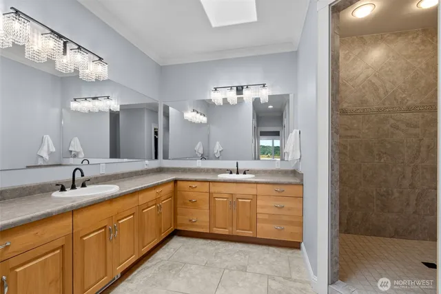 a spacious bathroom with a granite countertop sink mirror and shower