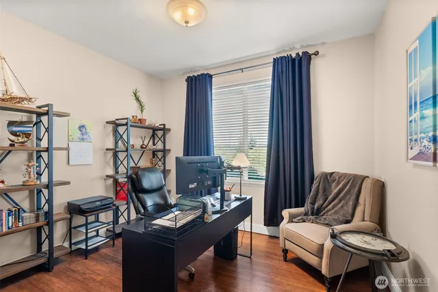 a living room with furniture a flat screen tv and a window