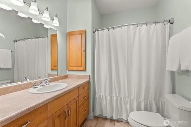 a bathroom with a sink a toilet and a mirror