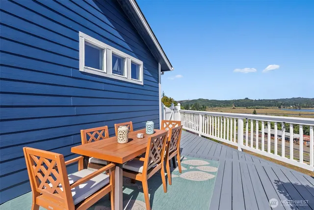 a backyard of a house with table and chairs