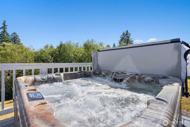 an aerial view of a house with a yard and lake view