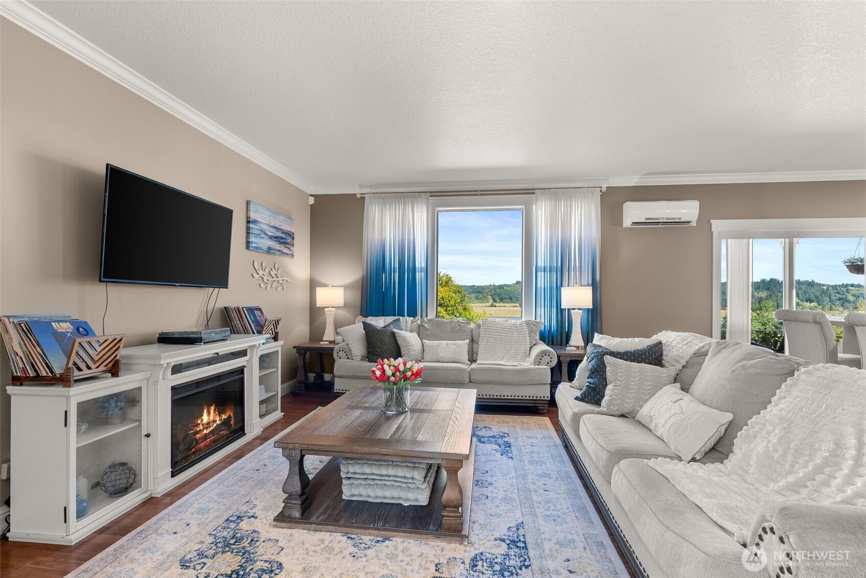 1480 Pacific Avenue Raymond, WA 98577 - Photo 4 of 40 a living room with furniture a flat screen tv and a fireplace