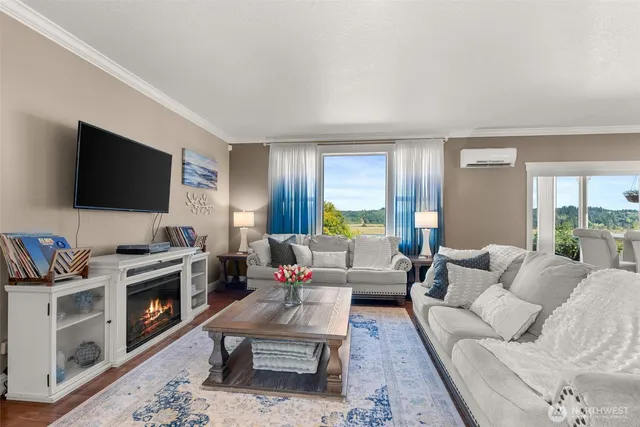 a living room with furniture a flat screen tv and a fireplace