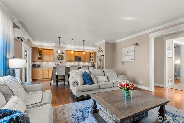 a living room with furniture kitchen view and a table