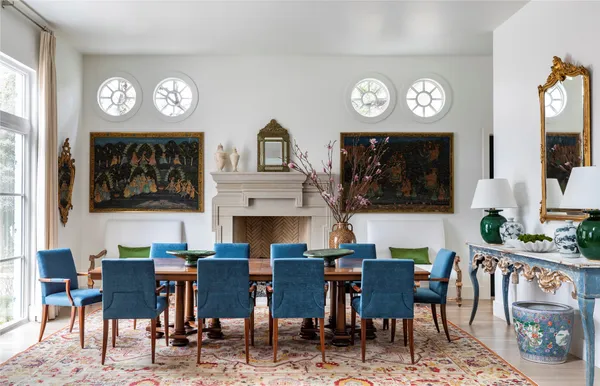 a view of a dining room with furniture a rug and a clock