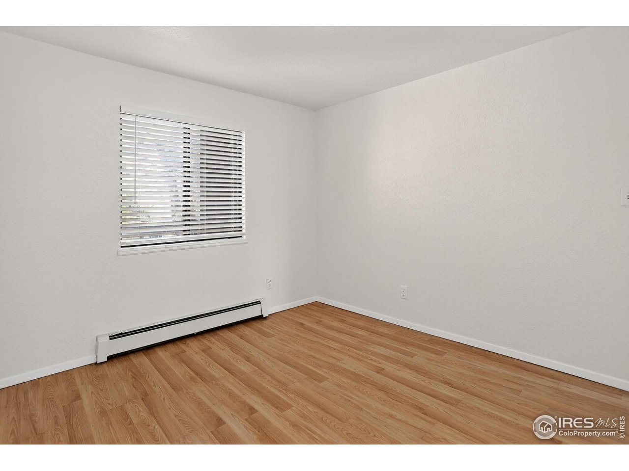 3535 28th Street, Unit 202 Boulder, CO 80301 - Photo 23 of 31 a view of an empty room with wooden floor and a window