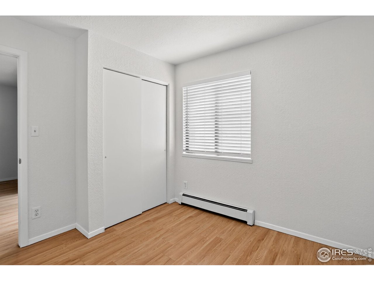 3535 28th Street, Unit 202 Boulder, CO 80301 - Photo 25 of 31 an empty room with wooden floor and windows