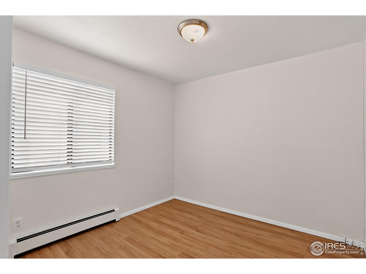3535 28th Street, Unit 202 Boulder, CO 80301 - Photo 26 of 31 a view of an empty room with wooden floor and a window