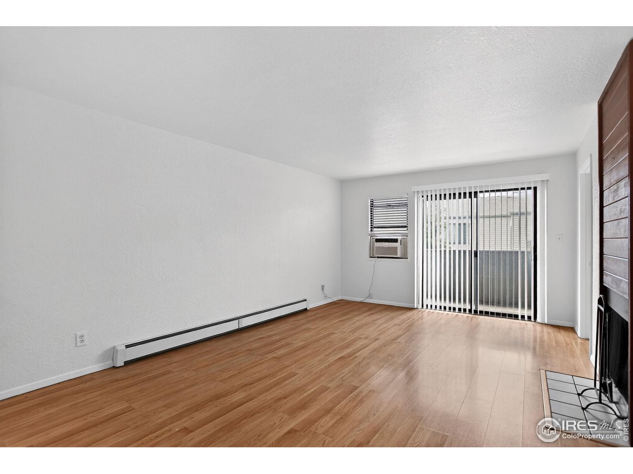 3535 28th Street, Unit 202 Boulder, CO 80301 - Photo 8 of 31 a view of an empty room with wooden floor and a window