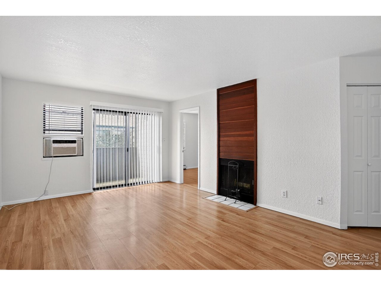 3535 28th Street, Unit 202 Boulder, CO 80301 - Photo 10 of 31 a view of an empty room with wooden floor and a window