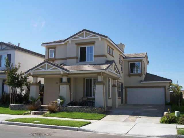 1804 Sheep Ranch Loop Chula Vista, CA 91913 - Photo 1 of 1 a front view of a house with a yard and garage