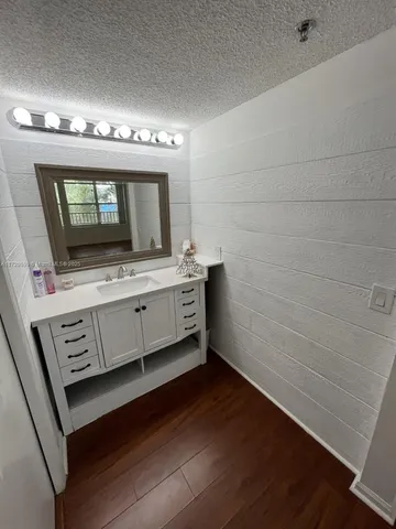 a bathroom with a sink a mirror and a toilet