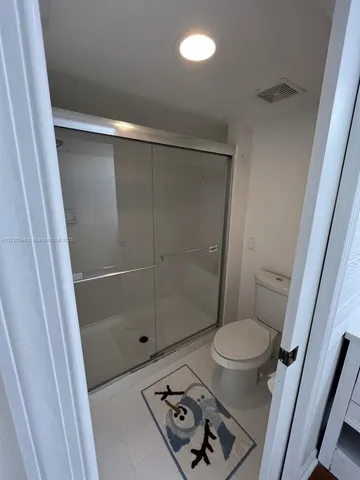 a bathroom with a shower and a toilet