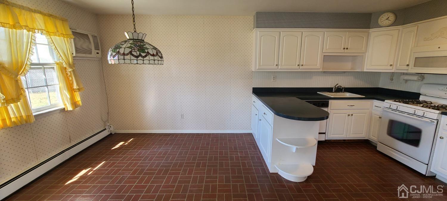 3 Stiles Road Edison, NJ 08817 - Photo 27 of 30 a kitchen with a sink a stove and cabinets
