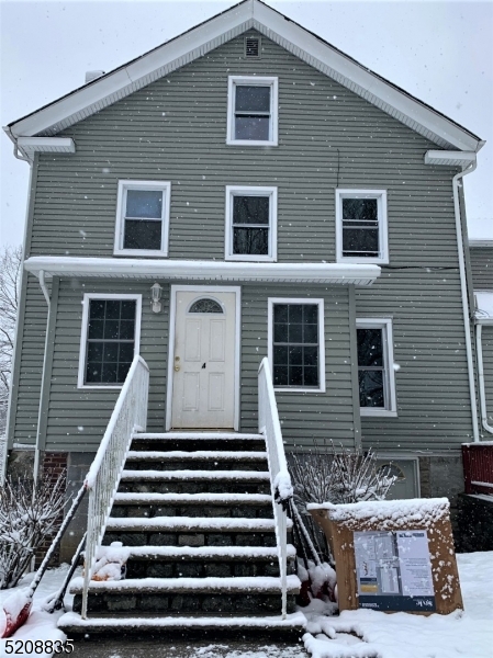 a front view of a house with stairs