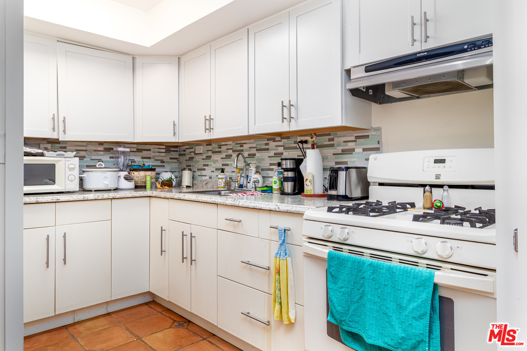 3938 Las Flores Canyon Road Malibu, CA 90265 - Photo 17 of 21 a kitchen with stainless steel appliances granite countertop a sink stove and cabinets