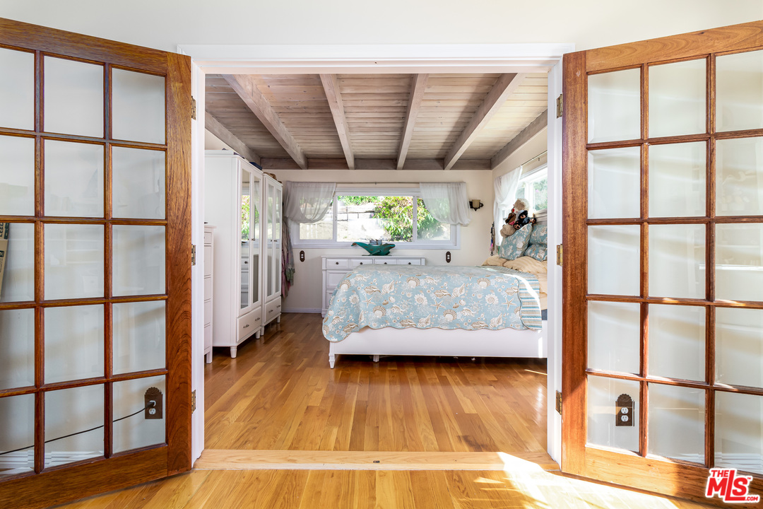 3938 Las Flores Canyon Road Malibu, CA 90265 - Photo 6 of 21 a bedroom with furniture and a large window