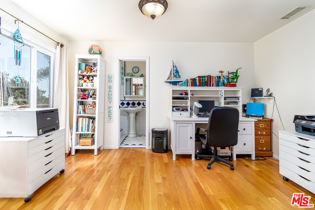 3938 Las Flores Canyon Road Malibu, CA 90265 - Photo 7 of 21 a view of a workspace with furniture and a bookshelf