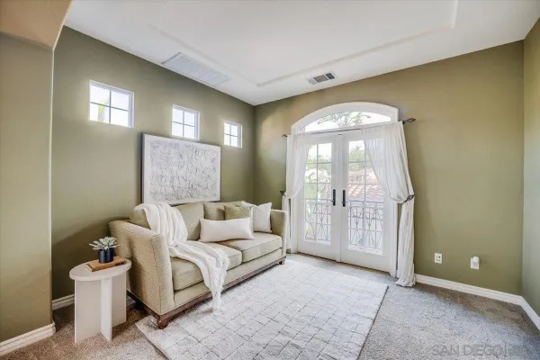a spacious bedroom with a bed and a chandelier