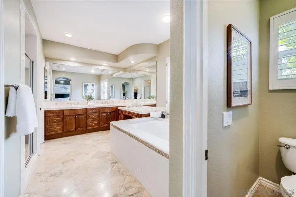 a large white kitchen with a large window