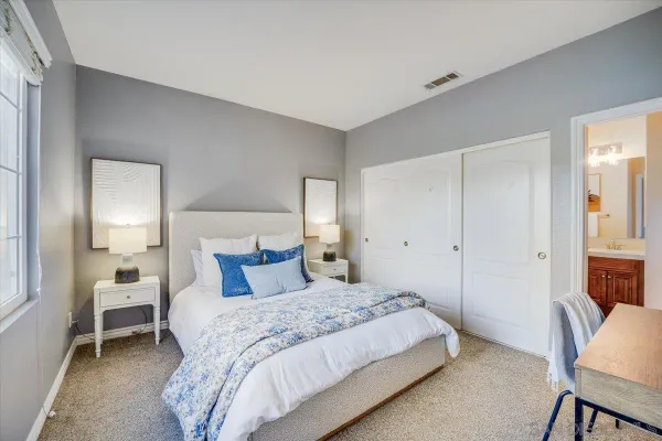a bedroom with a bed and a chair