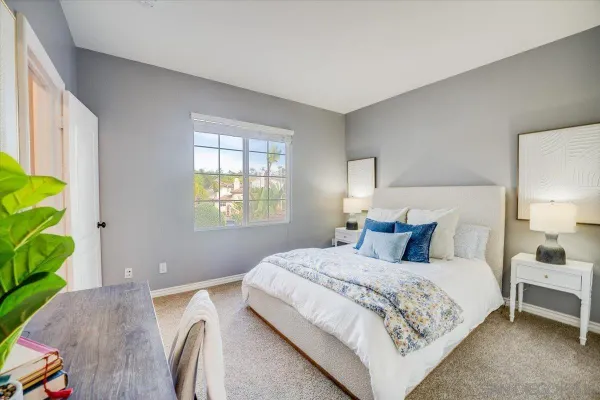 a bedroom with a bed and a window