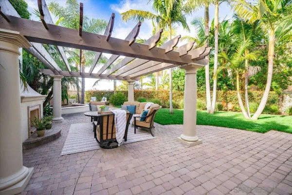 a view of a patio with couches table and chairs and potted plants